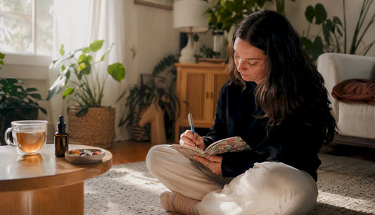 Woman journaling CBD daily effects at home table