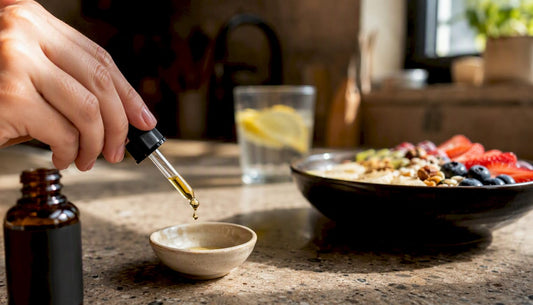 Close-up hand dropping CBD oil into dish
