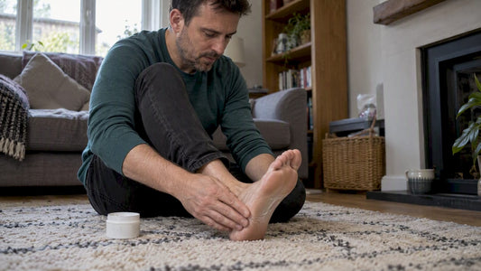 Man applying topical CBD to his foot
